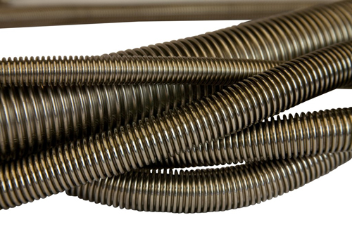Corrugated tube for transferring liquids and gases where pressures, high and low temperatures, or co